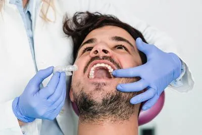 patient getting fitted for his new Invisalign clear aligners