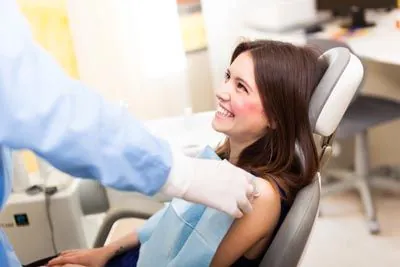 patient smiling during her dental appointment at Ember Dental Arts