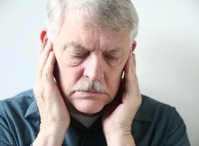 man suffering from TMJ pain