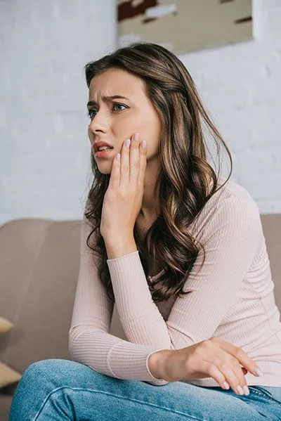 woman suffering from TMJ pain